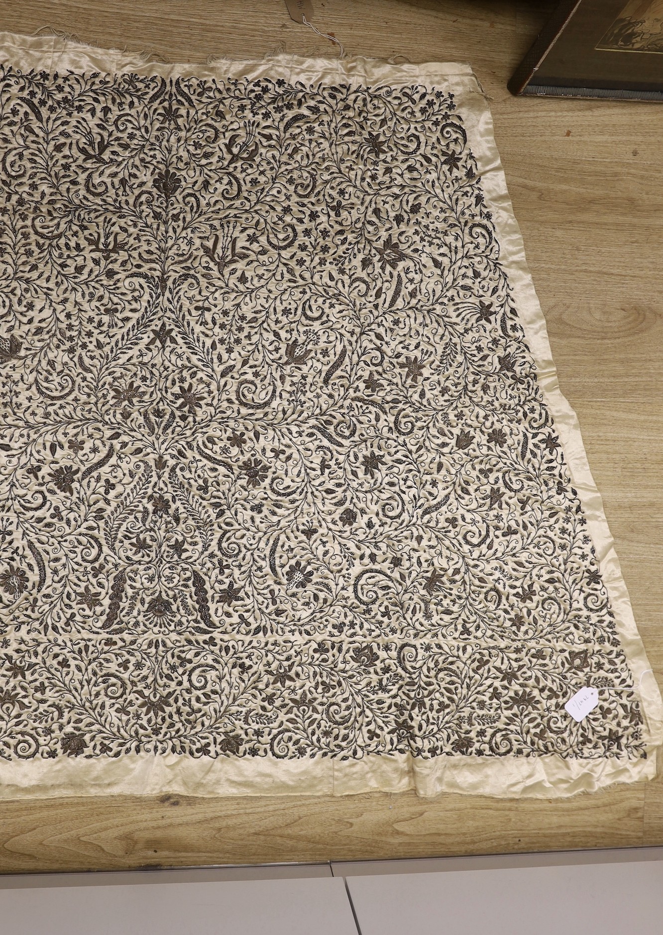 An Anglo-Indian, early Victorian ornate silver bullion, stump worked panel, on oyster satin silk, possibly a skirt panel to an evening gown, in three sections, the central panel 21 inches wide., 105cms long x 163cms at t